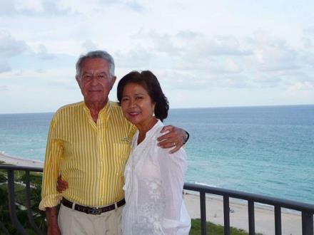 Couple on balcony overlooking the ocean