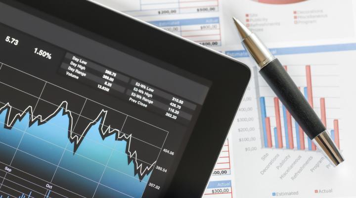Tablet showing financial charts with pen