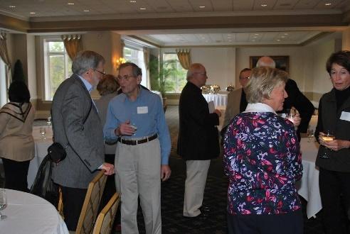 Small reception with guests conversing in ballroom