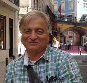 Man smiling on a city street.