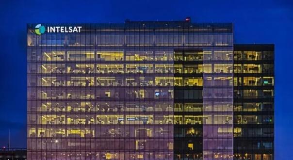 Intelsat headquarters glass facade lit at dusk