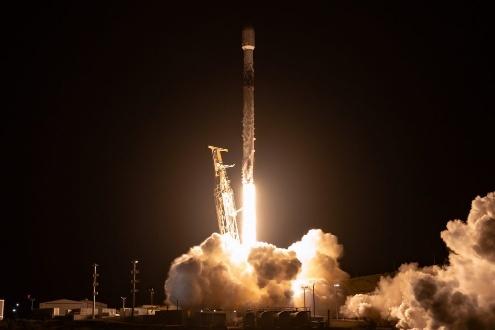 Rocket launching at night with bright exhaust