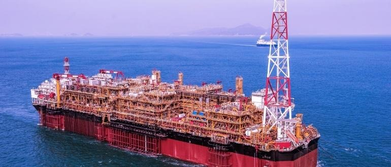 large offshore FPSO vessel with red hull