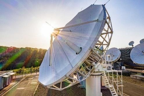 Large parabolic antenna dish catching sunlight