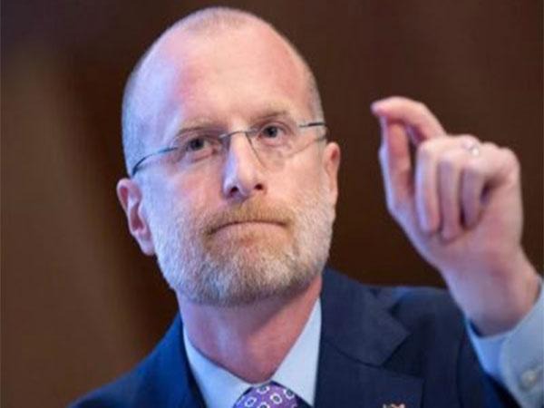 Bearded man in suit gesturing during hearing