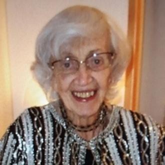 Smiling elderly woman wearing patterned blouse