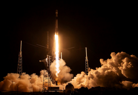 Nighttime rocket launch with bright exhaust plumes