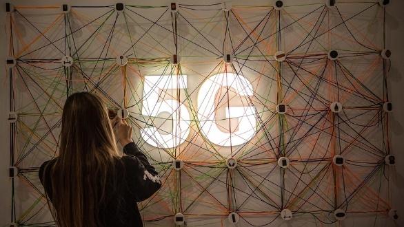 Person viewing illuminated 5G string art