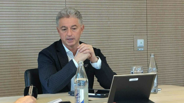 Man speaking at meeting with laptop