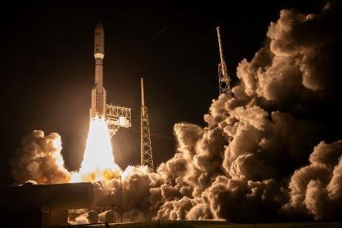 Nighttime rocket launch with billowing smoke