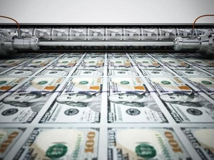 Stack of hundred-dollar bills being printed