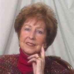 Smiling elderly woman portrait with hand on cheek