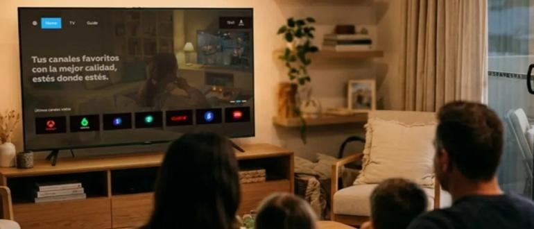 Family watching television in cozy living room
